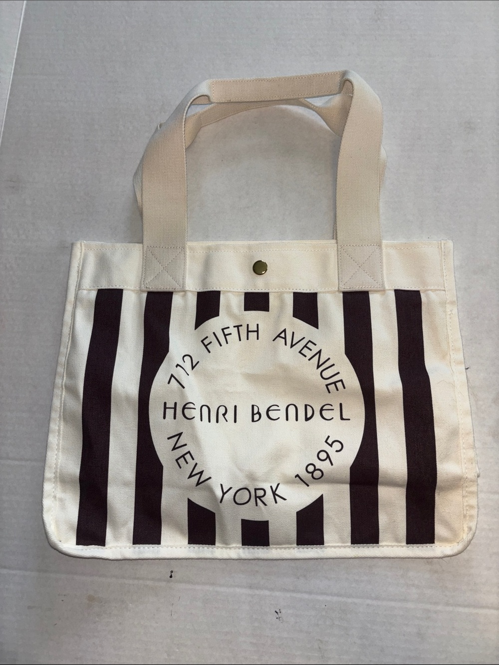 HENRI BENDEL CREAM AND DARK BROWN STRIPED CANVAS TOTE SNAP CLOSURE
LOOKS NEW